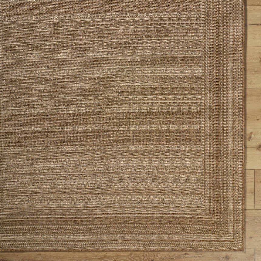 Close-up of the Freja Flatweave Faux Jute Rug. Beige and brown rug with a subtle, textured, striped pattern. Corner