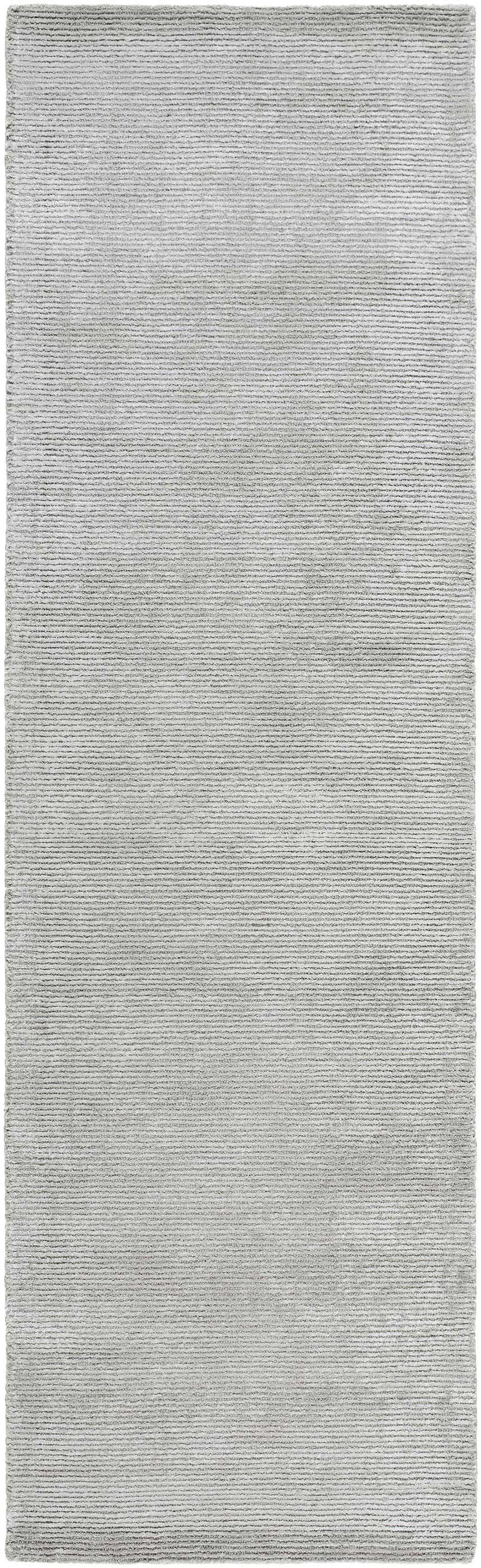 Close-up of the hand-tufted Noham Area Rug. Metallic silver, pale slate, and silver gray viscose create a contemporary design. Design-Runner-310