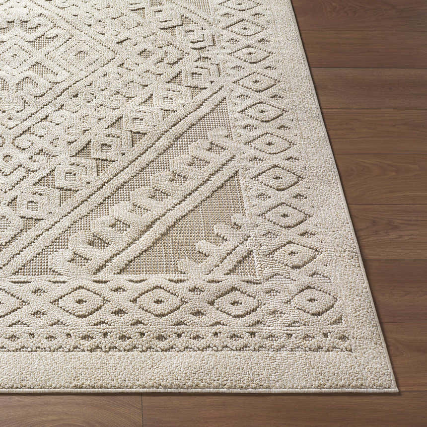 Close-up of the Hibah Bone Area Rug showing its geometric pattern and textured weave on a wood floor. Front