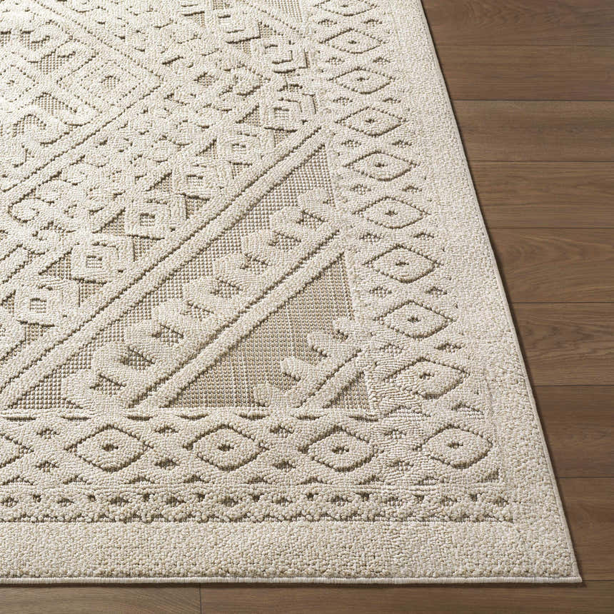 Close-up of the Hibah Bone Area Rug showing its geometric pattern and textured beige and bone color on a wood floor. Front