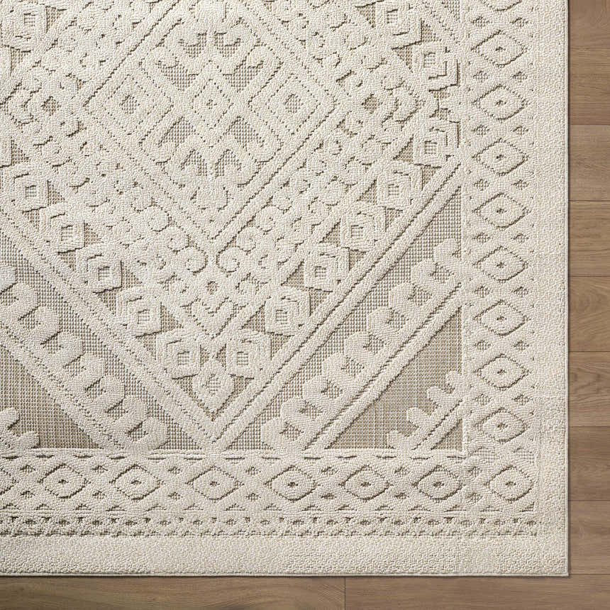 Close-up of the Hibah Bone Area Rug showing its contemporary geometric design and textured beige and bone color palette. Corner
