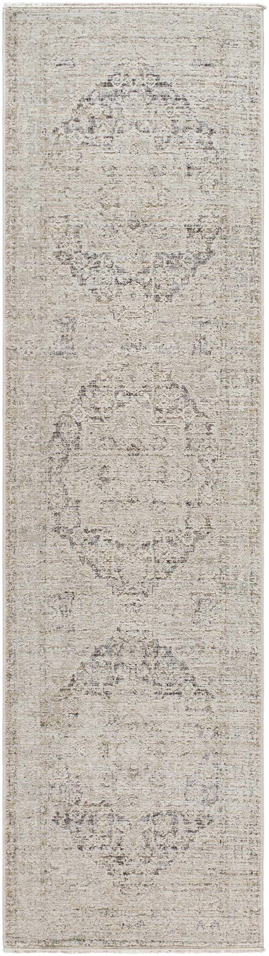 Close-up of the Njeri Area Rug. Beige farmhouse style with a traditional medallion pattern and subtle texture. Design-Runner-2710