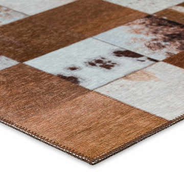 Close-up of the Dalyn Durango SS10 Driftwood Washable Area Rug. Features a patchwork design in brown, taupe, and gray tones.