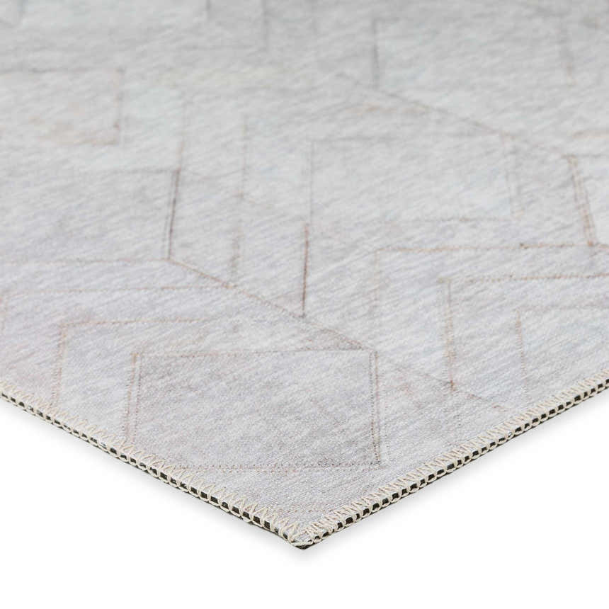 Close-up of the beige Dalyn Durango washable area rug showing the geometric pattern and textured weave.