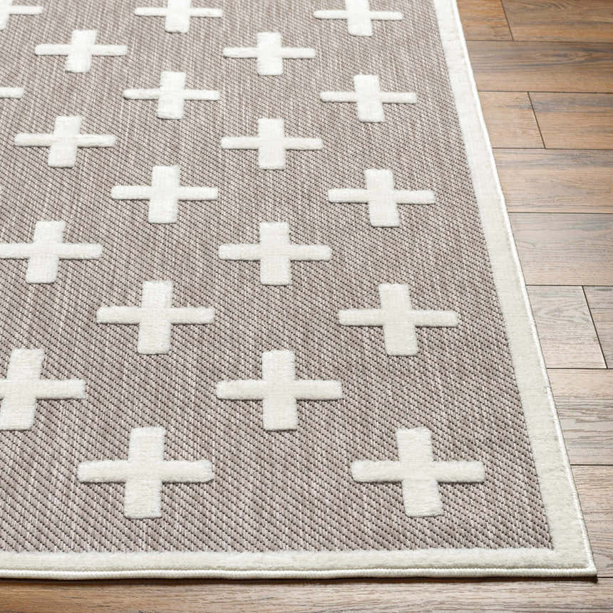 Close up of Alvar SFG-2341 area rug. Dark gray rug with raised white plus sign pattern and a white border. Front