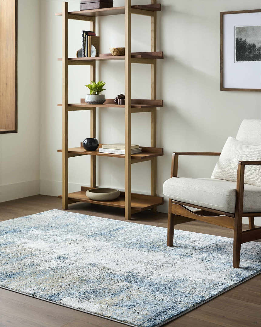 Living room with a Duval Blue Abstract Area Rug, wood shelving unit, and mid-century modern chair. Roomscene-Rectangle