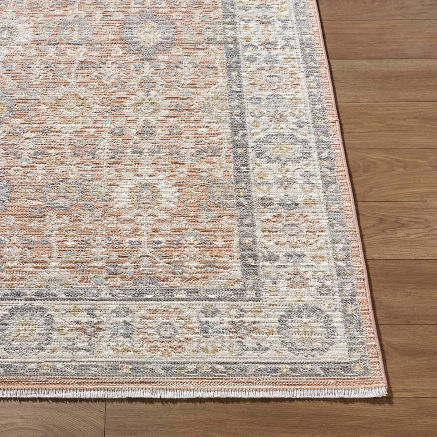 Close-up of the Adilet Dark Pink Washable Area Rug showing its traditional pattern, pink, gray, and cream colors, and woven texture. Front