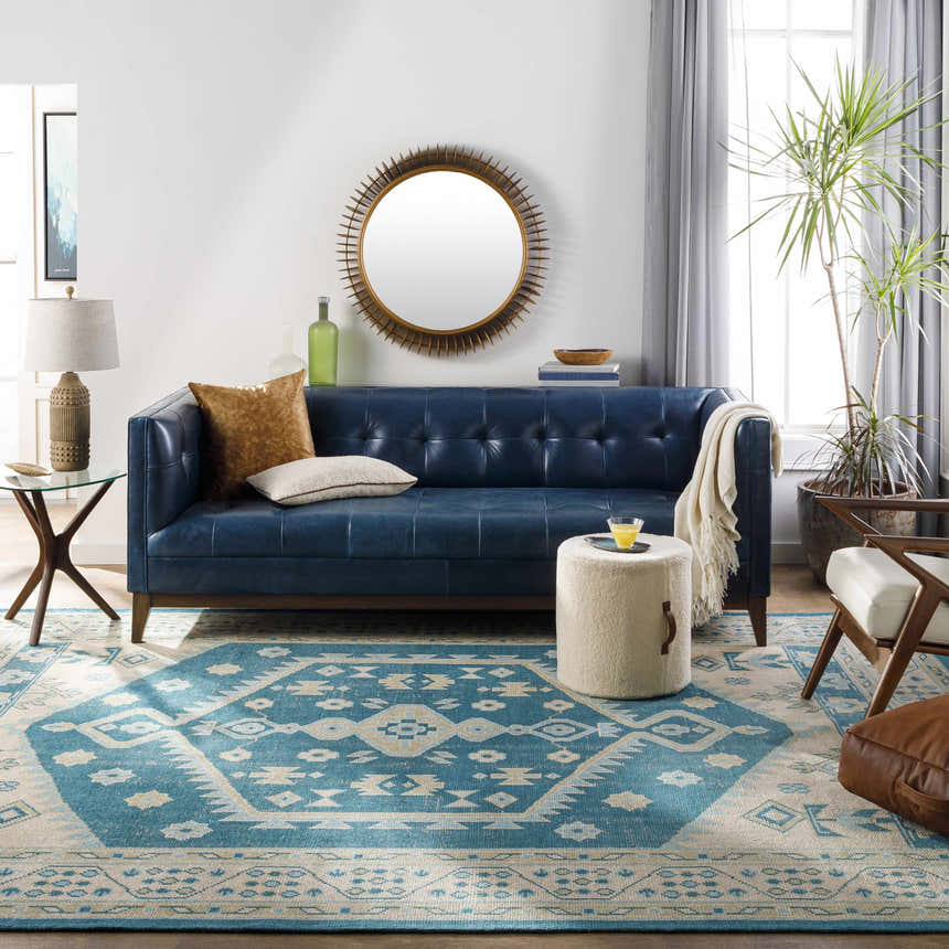 Living room scene with a blue leather sofa and the aqua Stepps Area Rug. Roomscene-Rectangle