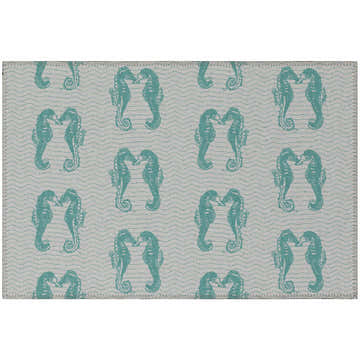 Close-up of Dalyn Seabreeze SZ15 Teal Washable Area Rug with seahorse and wave pattern. Coastal style.