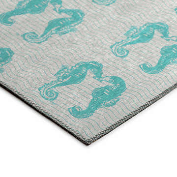Close-up of the Dalyn Seabreeze SZ15 Teal Washable Area Rug, featuring a seahorse pattern on a textured gray background.