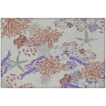 Close-up of Dalyn Seabreeze SZ1 Ivory Washable Area Rug with coral, starfish, and seashell coastal pattern. Beige, purple, spice tones.