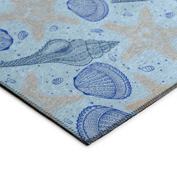 Close-up of the Dalyn Seabreeze SZ4 Sky Washable Area Rug. Coastal style with blue seashell and beige starfish pattern.