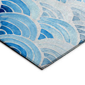 Close-up of Dalyn Seabreeze Poolside rug. Blue wave pattern on off-white background. Coastal style, machine-made.