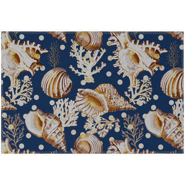 Close-up of the Dalyn Seabreeze Navy Washable Area Rug featuring a seashell, coral, and dot pattern.