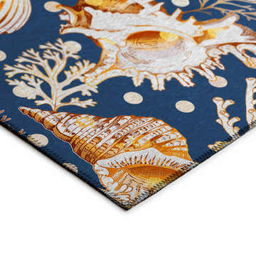 Close-up of Dalyn Seabreeze Navy Washable Area Rug. Features a coastal seashell and coral pattern in beige, brown, and off-white.