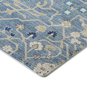 Close-up of the denim Dalyn Luxury Tabrook TB12 area rug with beige and navy floral pattern.