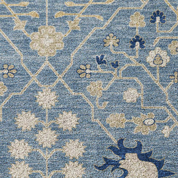 Close-up of the Dalyn Luxury Tabrook TB12 Denim Area Rug, showcasing its floral pattern and texture in beige, navy, and denim hues.