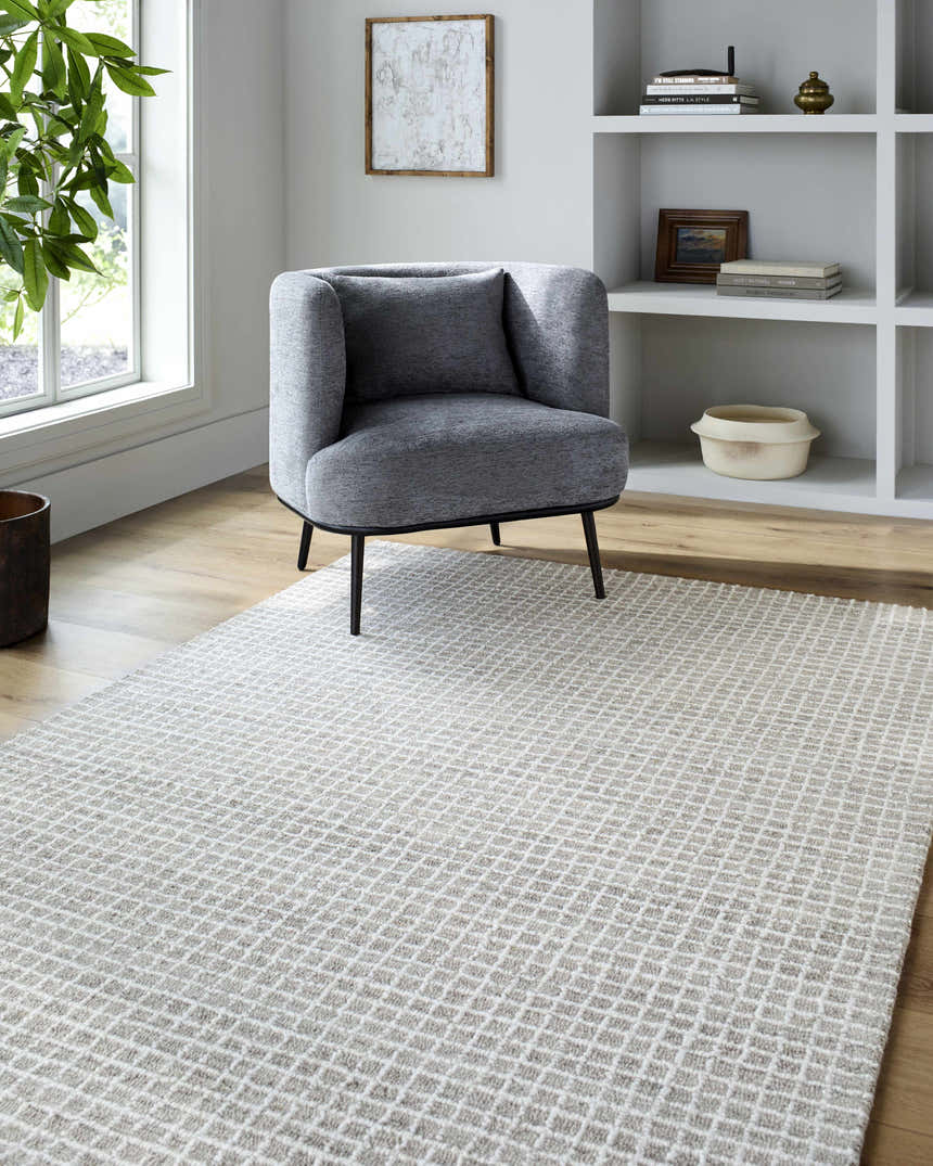 Living room scene with gray chair on Andreas Handmade Vivir x LIVABLISS VVAN-2302 rug in ash, dove gray, ivory, and pearl. Roomscene-Rectangle