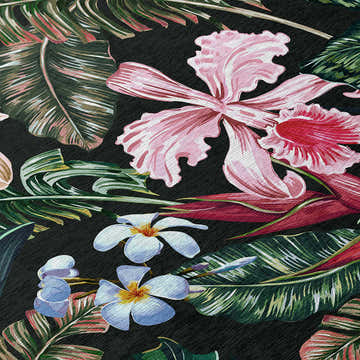 Close-up of Dalyn Tropics TC6 Black Washable Area Rug featuring pink orchids, white plumeria, and green tropical leaves.