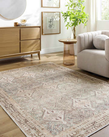 Living room scene with a beige Tzila Washable Area Rug, light wood floors, console table, and neutral armchair. Roomscene-Rectangle