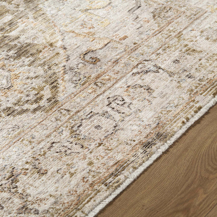 Close-up of the Avelyn Area Rug showing cream, dark brown, and red tones in a traditional, machine-woven pattern. Texture