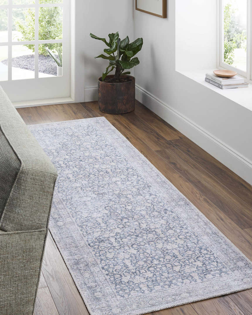 Living room scene with beige Lorelai runner rug, wood floors, gray sofa, and natural light from the window. Roomscene-Runner