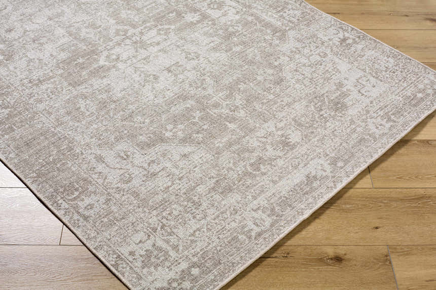 Close-up of the beige and ivory Tanko Washable Wool Area Rug showing its traditional pattern and hand-woven texture. Corner