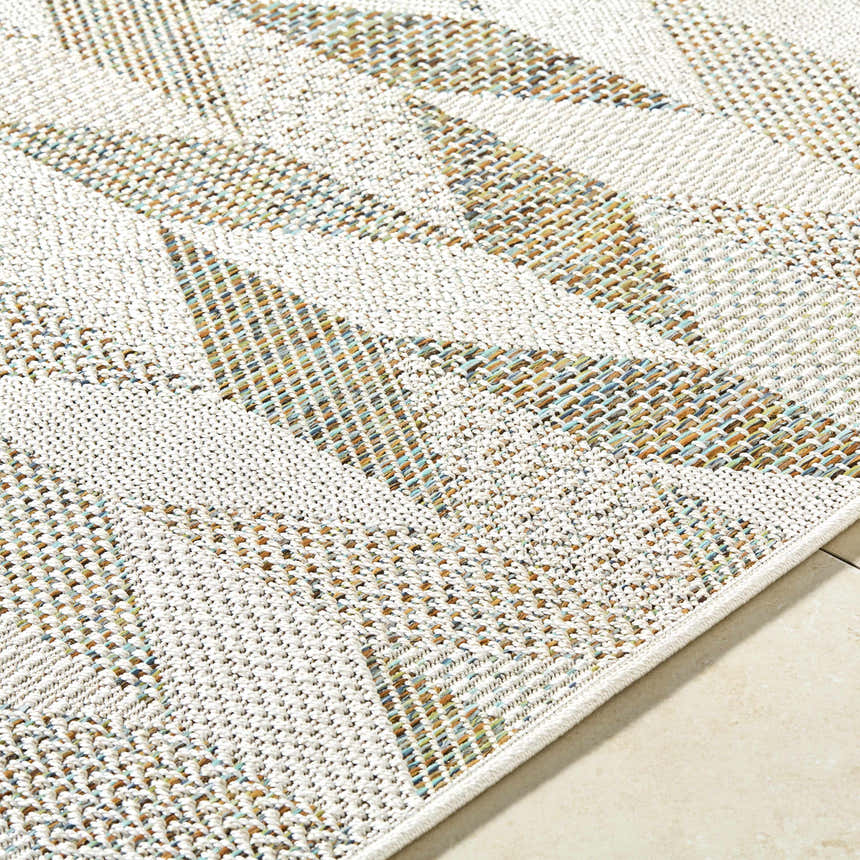 Close up of Andrea Ivory Area Rug showing the woven texture and geometric pattern in ivory, sage, sandstone and sky blue. Texture