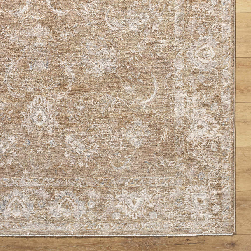 Close up of the Tylie Tan Area Rug showing its light brown, cream, and olive floral pattern and machine woven texture. Corner