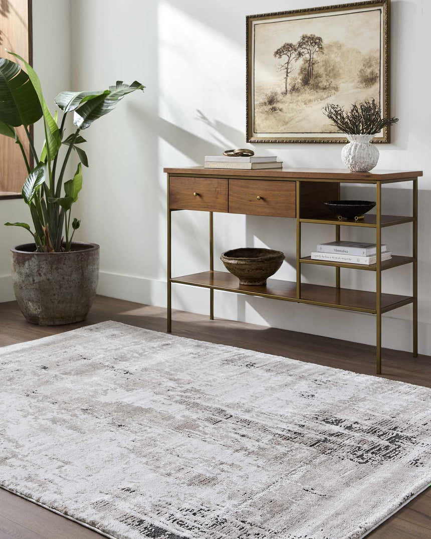 Living room scene with a tan console table and the Taszi Luxe Thick Area Rug in black, ivory, peach, and tan. Roomscene-Rectangle