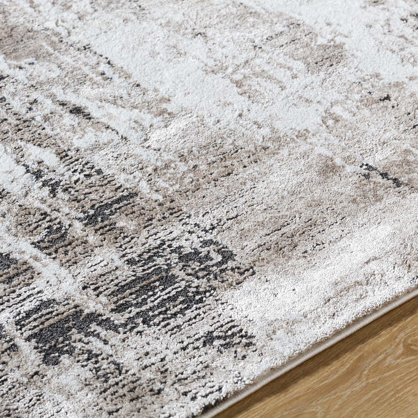 Close up of the Taszi Luxe Thick Area Rug showing black, ivory, peach, and tan colors and a contemporary design. Texture