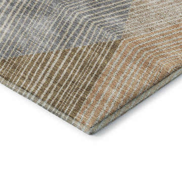 Close-up of Dalyn Luxury The Reserve TR11 Copper Washable Area Rug with geometric pattern in beige, caramel, and taupe.