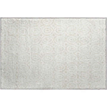 Close-up of the ivory Dalyn Luxury The Reserve TR12 rug. Geometric pattern, soft texture, and light beige color.
