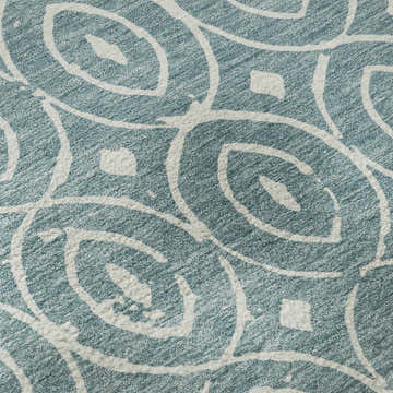Close up of Dalyn Luxury The Reserve TR12 Turquoise Washable Area Rug with a geometric aqua and white pattern.