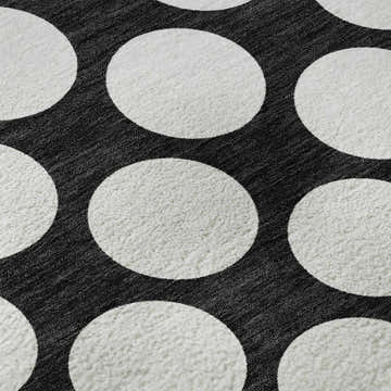 Close up of Dalyn Luxury The Reserve TR13 Black Washable Area Rug with a black and off white geometric polka dot pattern.
