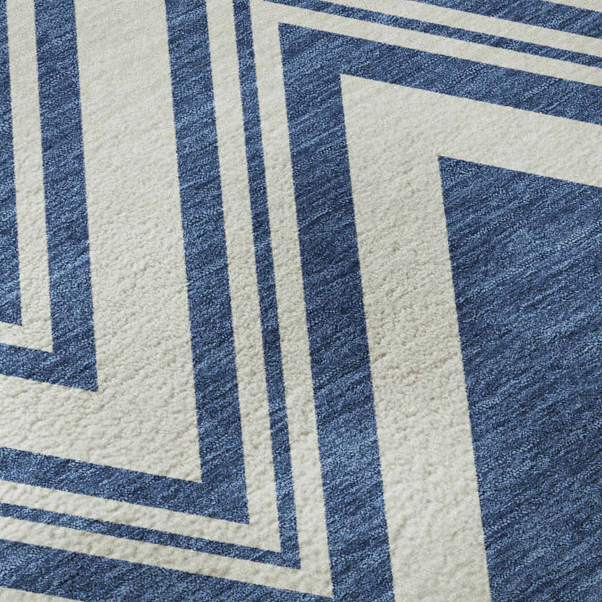 Close-up of Dalyn Luxury The Reserve TR17 Blue Washable Area Rug with a geometric pattern in light blue and chestnut.