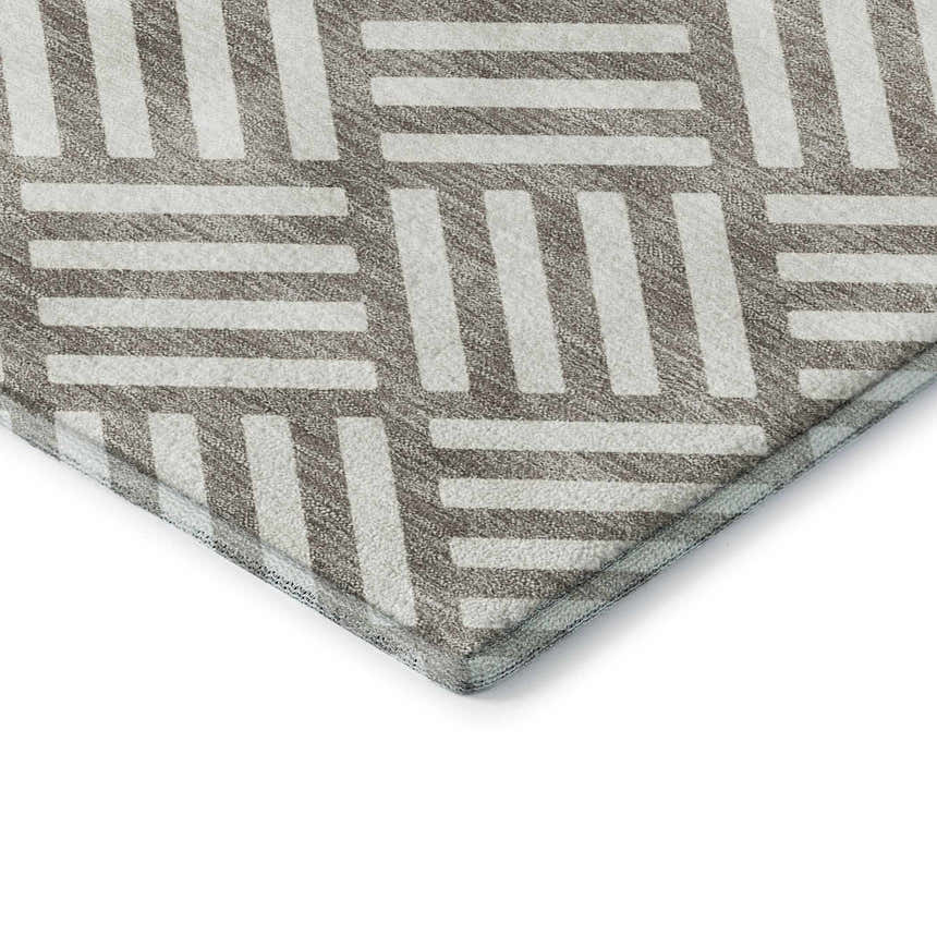 Close-up of Dalyn Luxury The Reserve TR3 Taupe Washable Area Rug with a geometric pattern in chestnut and ivory.