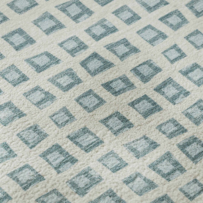Close-up of the Dalyn Luxury Indoor/Outdoor The Reserve TR4 Teal Washable Area Rug with a geometric diamond pattern.