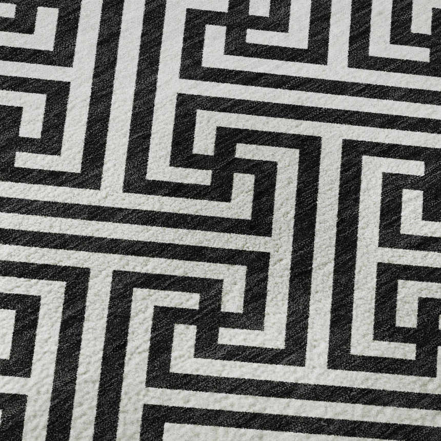 Close-up of the Dalyn Luxury The Reserve TR5 Black Washable Area Rug featuring a geometric black and white pattern.