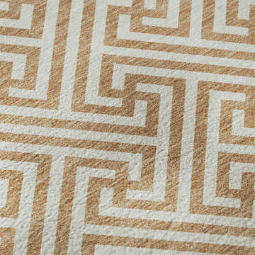 Close-up of the Dalyn Luxury The Reserve TR5 Copper Washable Area Rug, featuring a beige and caramel geometric pattern.