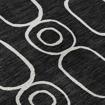Close-up of Dalyn Luxury Indoor/Outdoor The Reserve TR6 Black Washable Area Rug with a geometric off-white circle pattern.