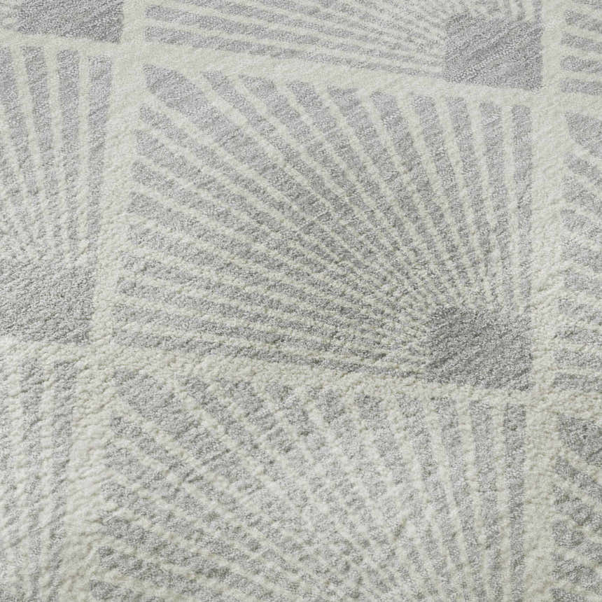 Close-up of the Dalyn Luxury Indoor/Outdoor The Reserve TR9 Silver Washable Area Rug featuring a geometric silver and white pattern.