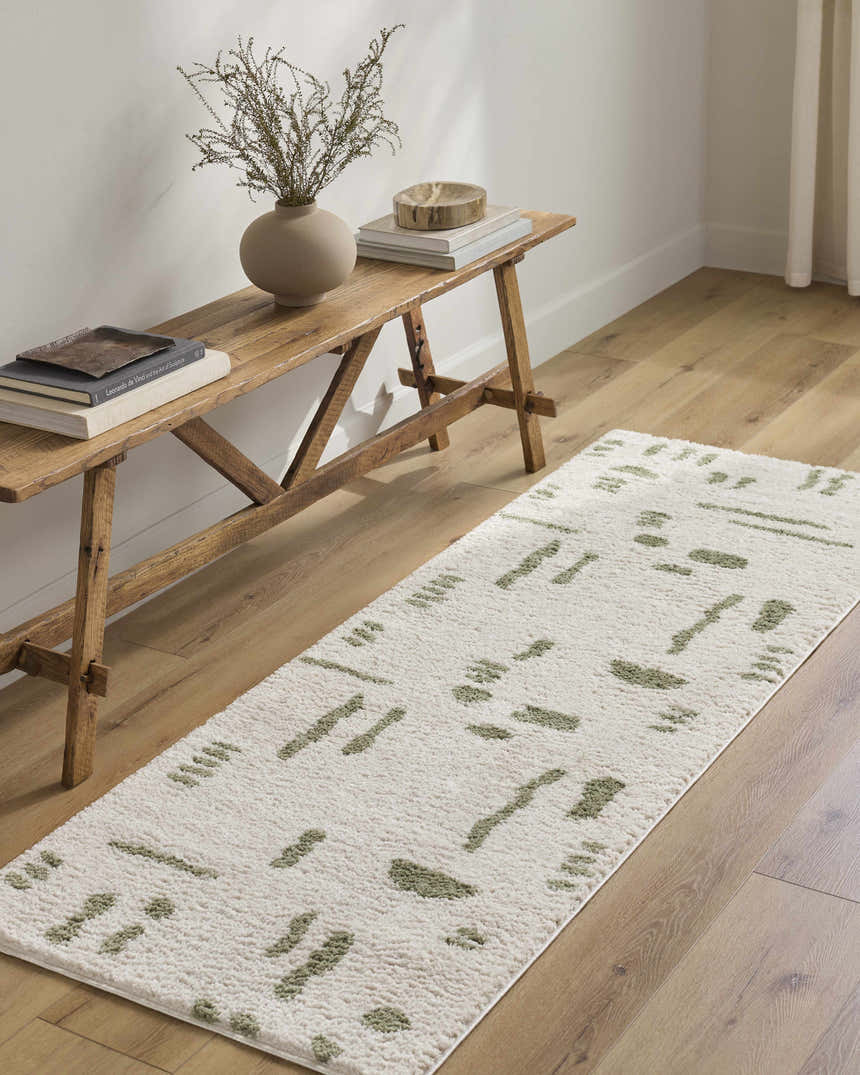Hallway scene with Azriel Green Washable Area Rug. Rustic wood bench with vase and books. Modern, neutral decor. Roomscene-Runner