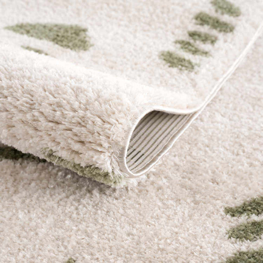 Close-up of the Azriel Green Washable Area Rug showing its plush texture and lime green geometric pattern. Fold