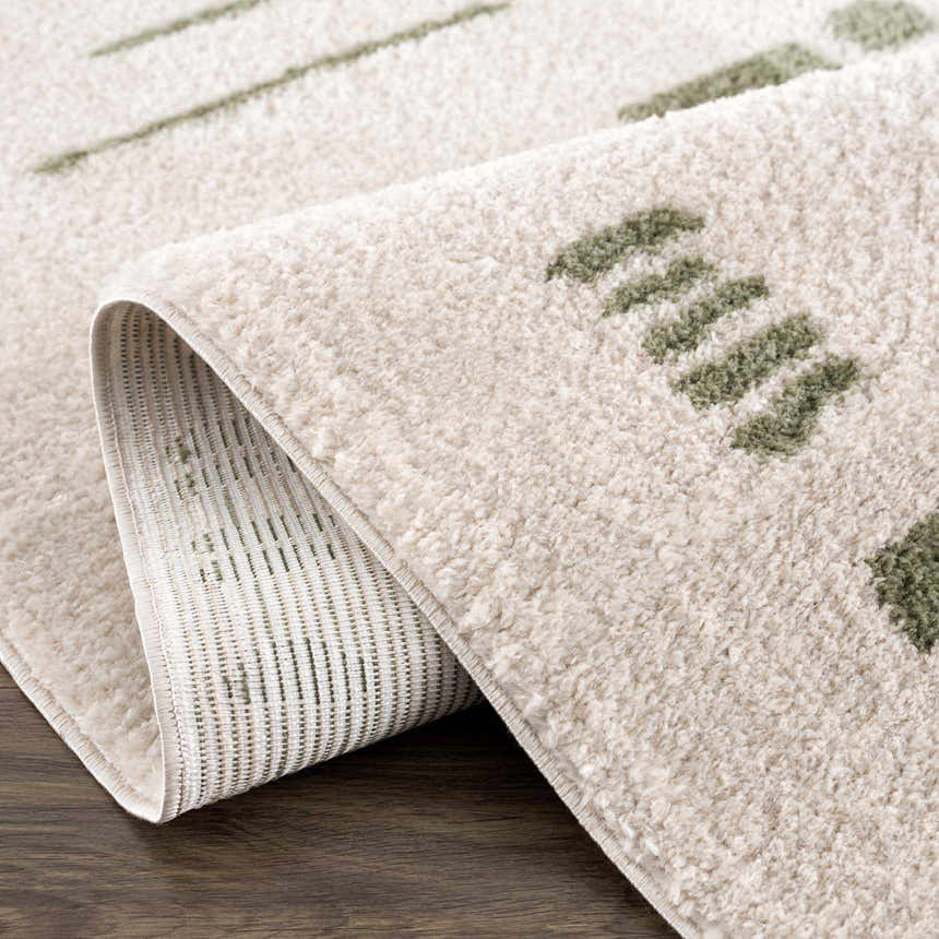 Close-up of the Azriel Green Washable Area Rug showing its soft texture and lime green geometric dash pattern. Fold