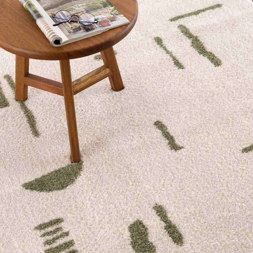 Close-up of the Azriel Green Washable Area Rug, showing its soft texture and lime green abstract pattern. Styleshot