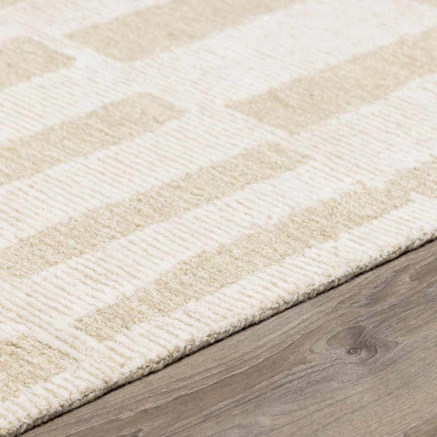 Close-up of the hand-tufted Teige Light Silver Area Rug. Wool rug with geometric pattern in light silver and sterling gray. Pile