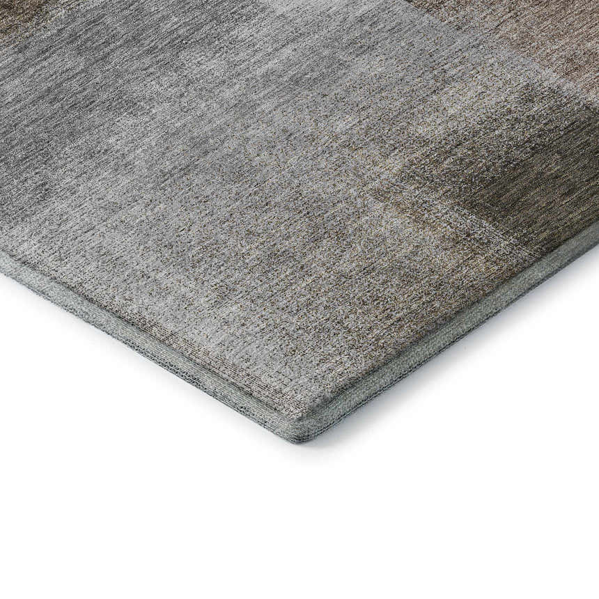 Close-up of Dalyn Luxury Trevi TV10 Pewter Washable Area Rug. Features beige, brown, and gray tones with a subtle, textured pattern.