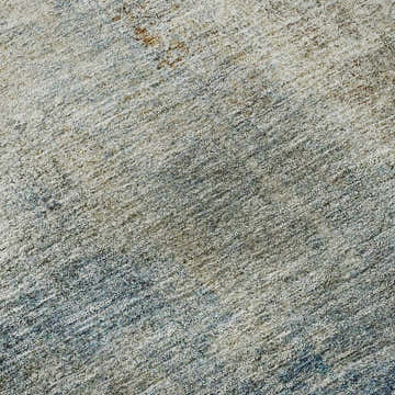 Close-up of Dalyn Luxury Trevi TV5 Taupe Washable Area Rug showing texture and colors: taupe, beige, denim, and ivory.