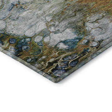 Close-up of the Dalyn Luxury Trevi TV7 Paprika Washable Area Rug. Features beige, blue, green, and gold abstract pattern.